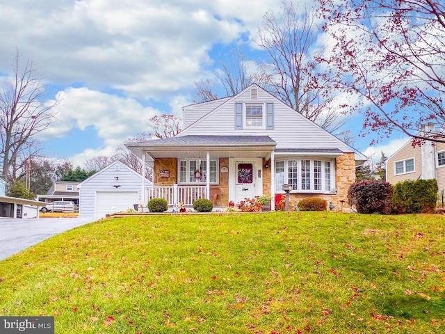 bungalow featuring a garage, a front lawn, and an outdoor structure