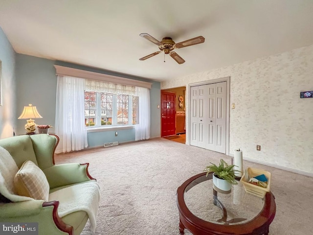 sitting room with carpet and ceiling fan