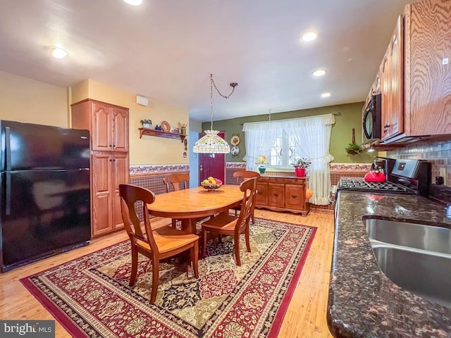 dining room featuring sink and light wood-type flooring