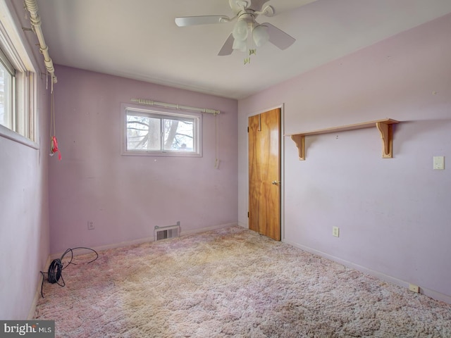 unfurnished bedroom with carpet, ceiling fan, and multiple windows