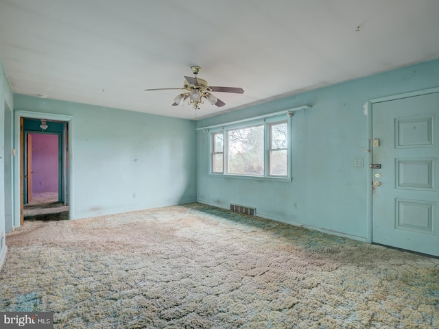 interior space with carpet floors and ceiling fan