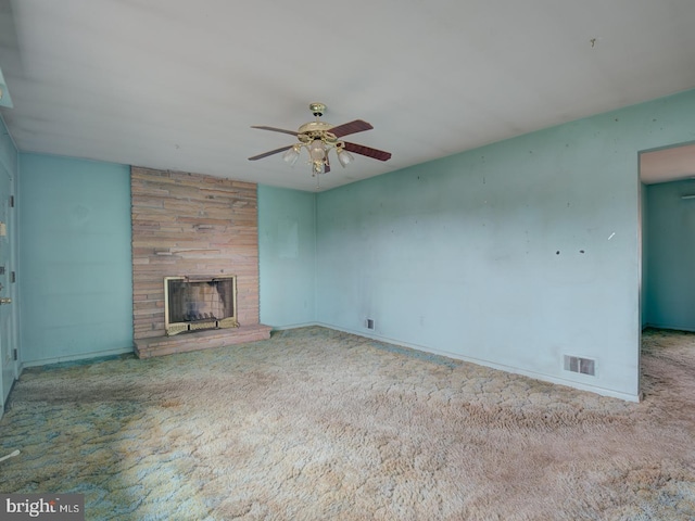 unfurnished living room with carpet, a fireplace, and ceiling fan