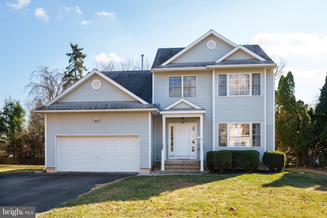 view of front of house featuring a garage and a front lawn