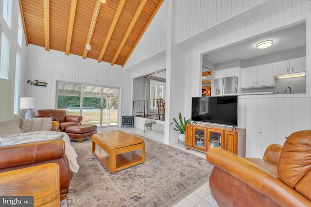 tiled living room featuring beam ceiling, wood walls, high vaulted ceiling, and wood ceiling