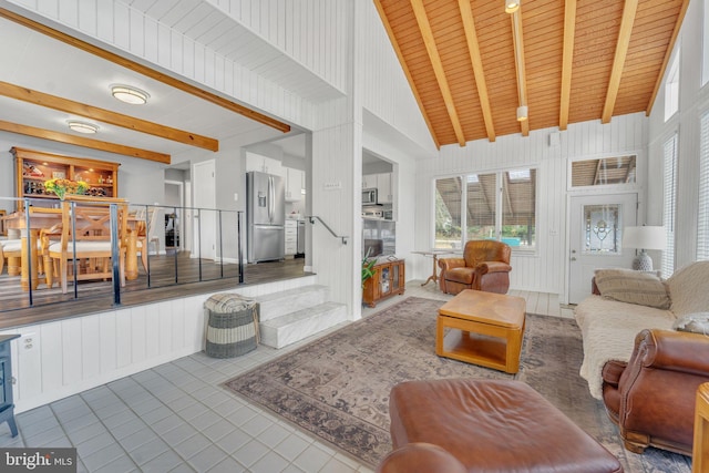 tiled living room featuring beam ceiling, wooden ceiling, and high vaulted ceiling