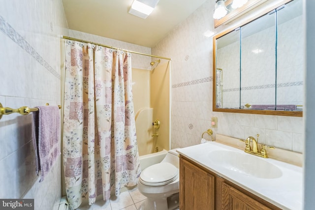 full bathroom with vanity, tile patterned floors, toilet, tile walls, and shower / tub combo