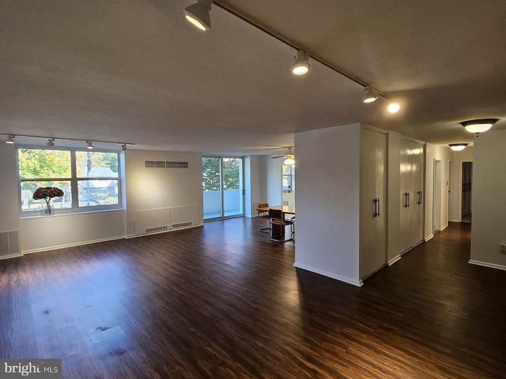7301 Coventry Ave Unit 210, Elkins Park, PA 19027 - empty room with rail lighting, a textured ceiling, dark wood-type flooring, and baseboards