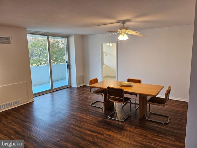 dining area with ceiling fan and dark hardwood / wood-style flooring