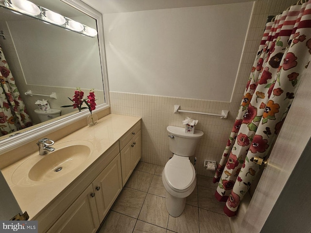 bathroom featuring tile patterned floors, toilet, vanity, tile walls, and a shower with shower curtain