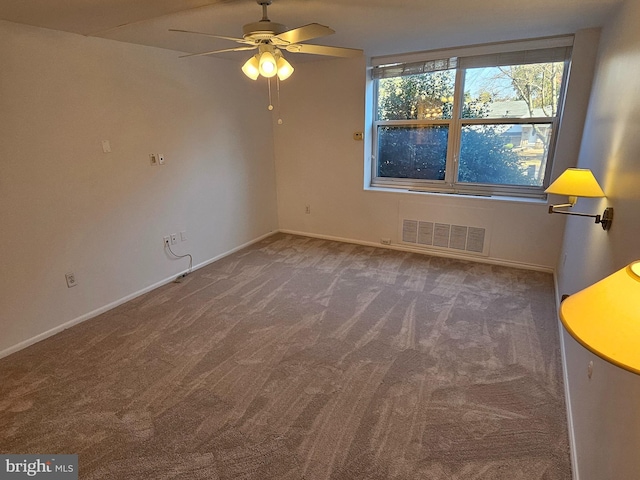 carpeted empty room featuring ceiling fan