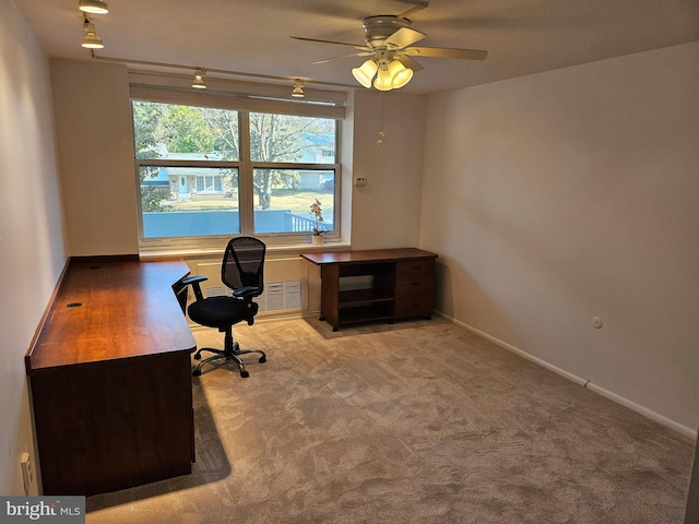 office space featuring light carpet and ceiling fan