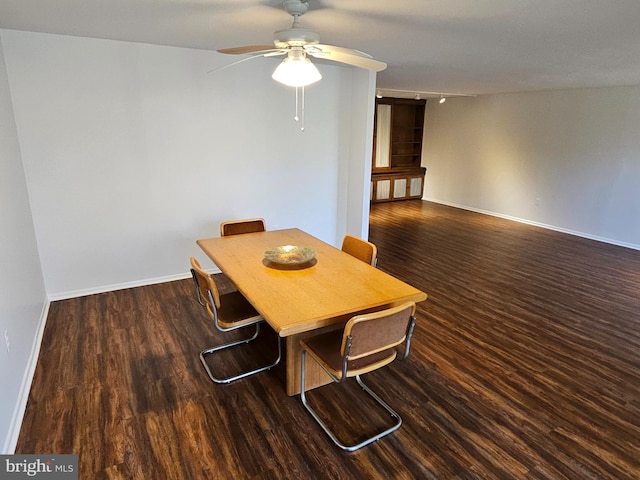 dining space with dark hardwood / wood-style floors and ceiling fan