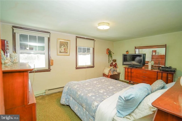 carpeted bedroom with baseboard heating and multiple windows