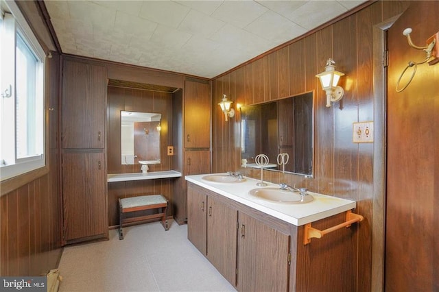 bathroom featuring vanity and wooden walls