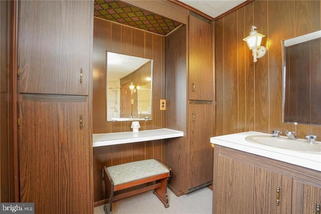 bathroom featuring vanity and wooden walls