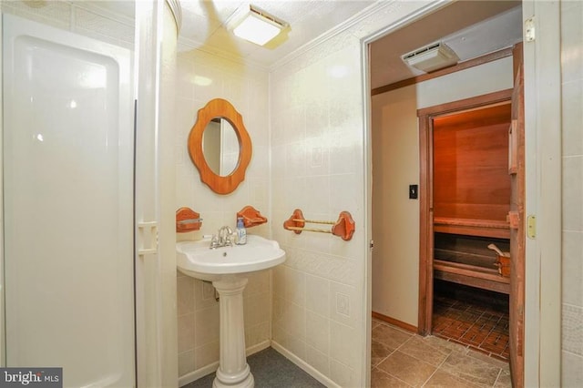 bathroom featuring tile patterned floors, tile walls, and ornamental molding