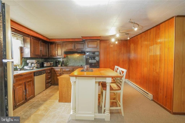 kitchen featuring dishwasher, a center island, oven, decorative backsplash, and butcher block countertops