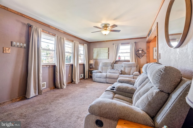 living room featuring ceiling fan, light carpet, and ornamental molding