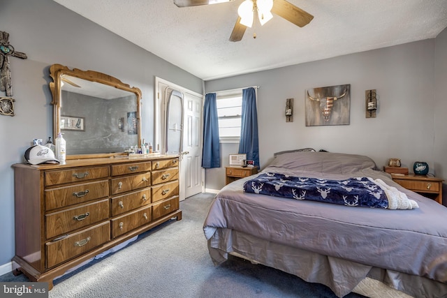 bedroom with carpet flooring, ceiling fan, and a textured ceiling