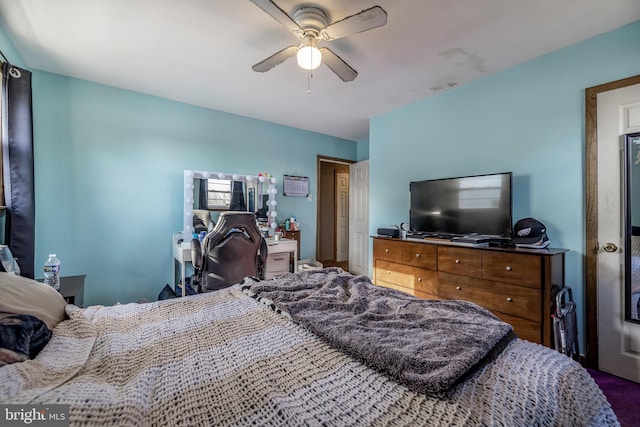 bedroom featuring ceiling fan and carpet