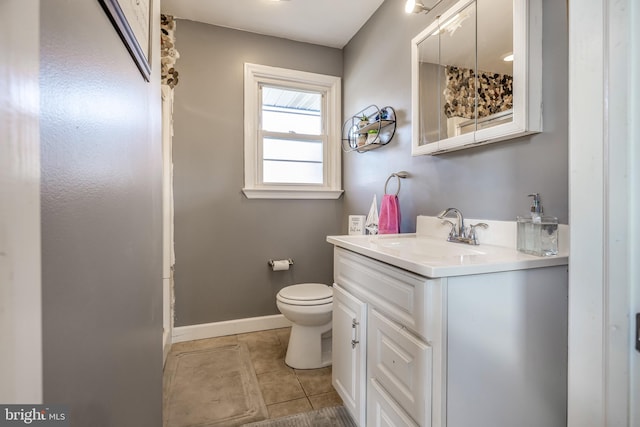 bathroom featuring tile patterned flooring, vanity, and toilet