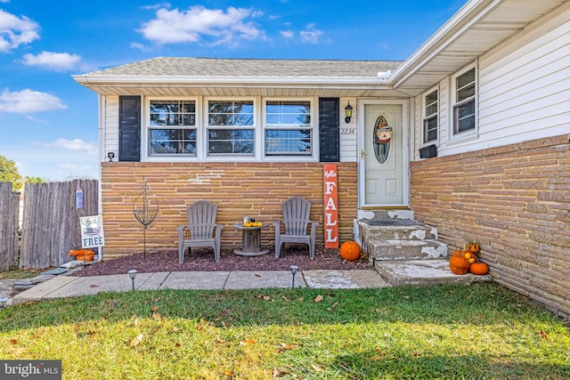 doorway to property with a yard