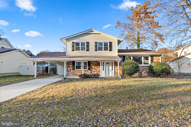 tri-level home with a front yard and a carport