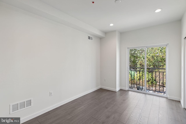 unfurnished room featuring dark hardwood / wood-style flooring