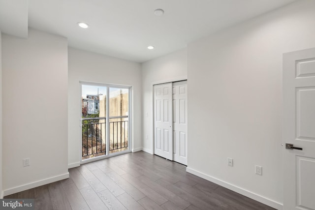 spare room with dark wood-type flooring