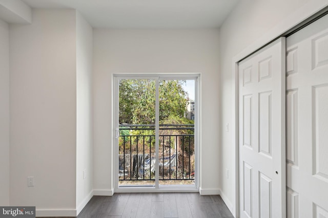 hall with hardwood / wood-style floors