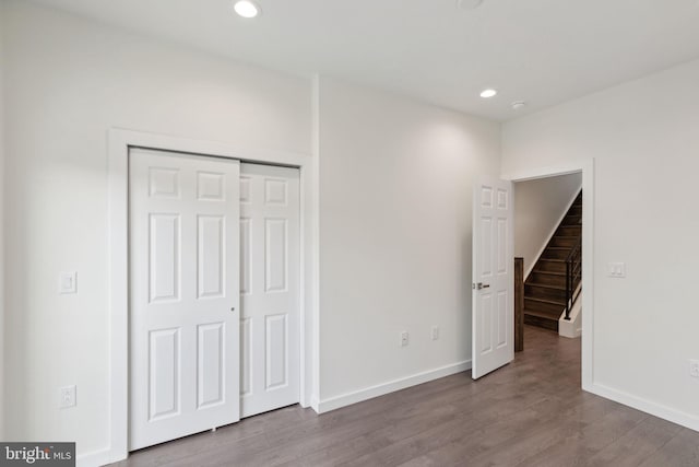 unfurnished bedroom featuring a closet and wood-type flooring