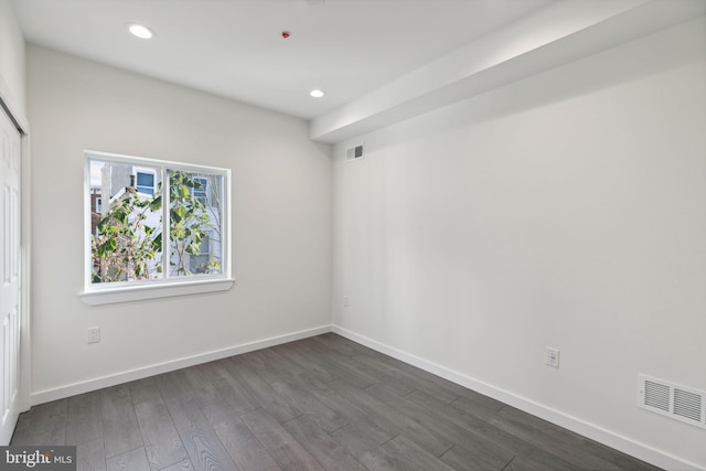 spare room featuring dark hardwood / wood-style floors