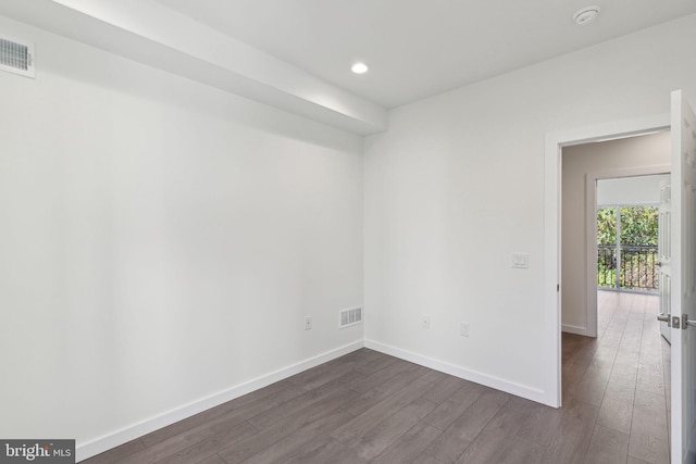 empty room with dark wood-type flooring