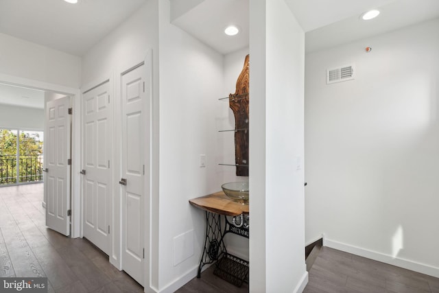 hallway with dark hardwood / wood-style flooring