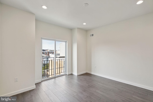 spare room with wood-type flooring