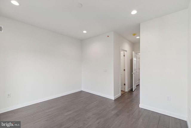 spare room featuring dark hardwood / wood-style floors