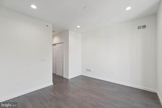 empty room with dark wood-type flooring