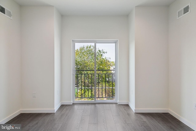 unfurnished room with hardwood / wood-style flooring