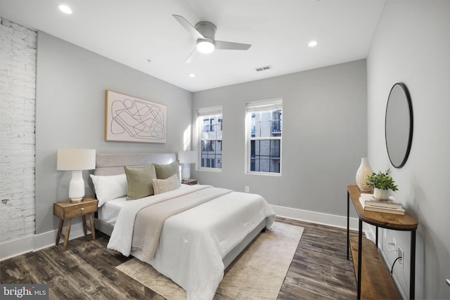 bedroom with ceiling fan and dark wood-type flooring