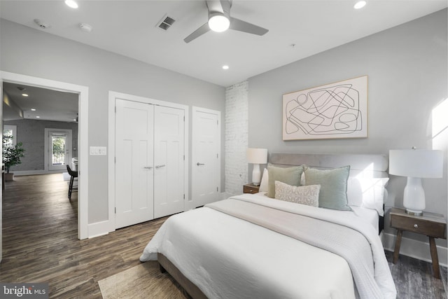 bedroom featuring ceiling fan, dark wood-type flooring, and a closet