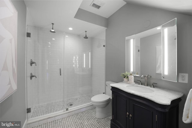 bathroom with toilet, vanity, and walk in shower