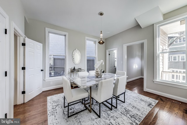 dining area featuring dark hardwood / wood-style flooring and a healthy amount of sunlight