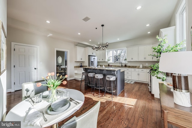 dining space with dark wood-type flooring and sink