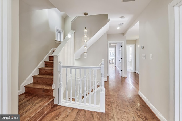 stairs featuring hardwood / wood-style flooring