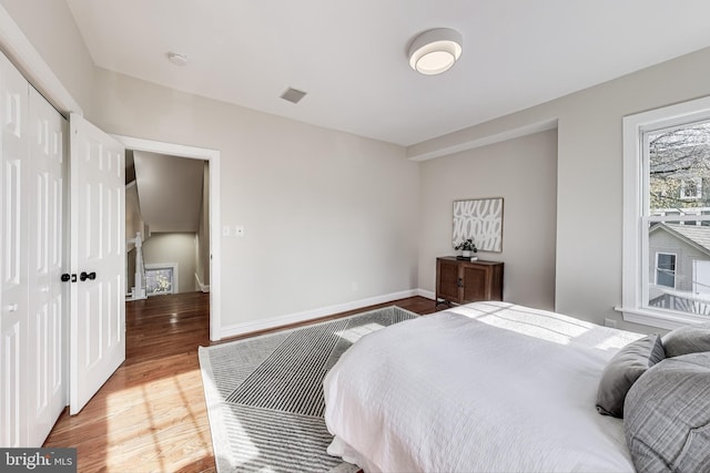 bedroom with a closet and hardwood / wood-style floors