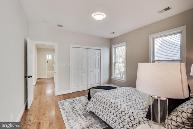 bedroom featuring light wood-type flooring and a closet