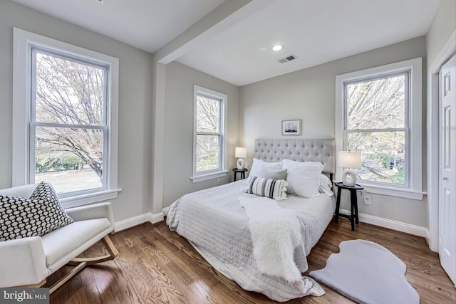 bedroom with dark wood-type flooring