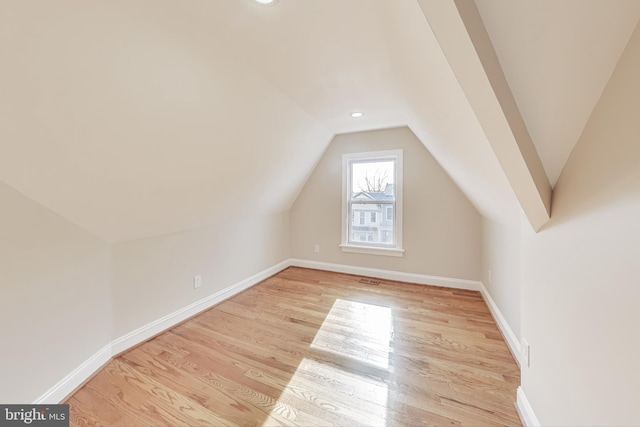 bonus room featuring light hardwood / wood-style floors and lofted ceiling