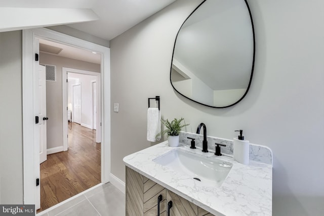 bathroom with hardwood / wood-style flooring and vanity