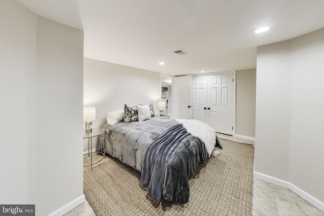 bedroom featuring a closet and light tile patterned floors